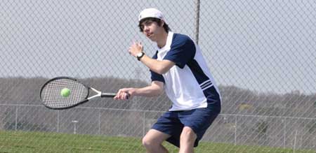 Image of tennis player with racket and ball