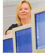 Image of a woman with computer monitors