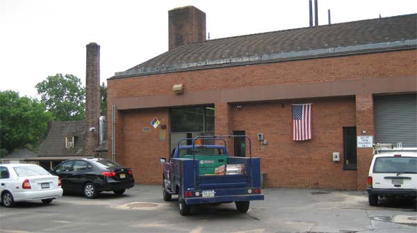 Image of building on campus including some vechiles