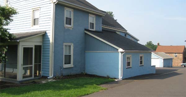 Image of blue house located on campus