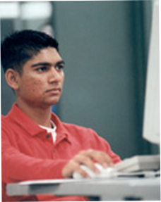 Image of a student using a mouse looking at a monitor screen