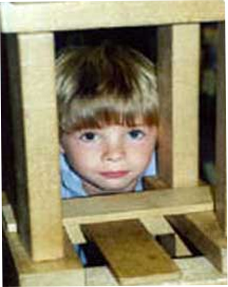 Image of little boy looking through wood square