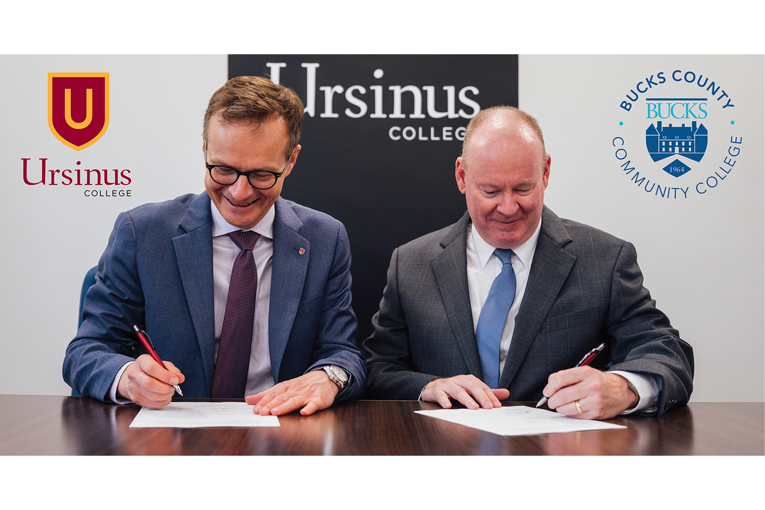 Ursinus President Gundolf Graml, Ph.D., and Bucks County Community College President and CEO Patrick M. Jones, Ph.D., sign an agreement