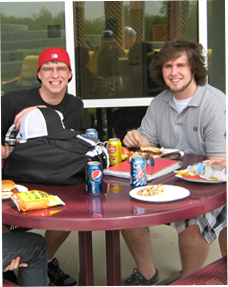 Image of 2 male students sitting outside eating