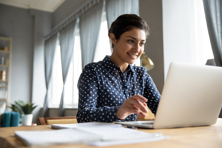 Female working on a laptop at a desk