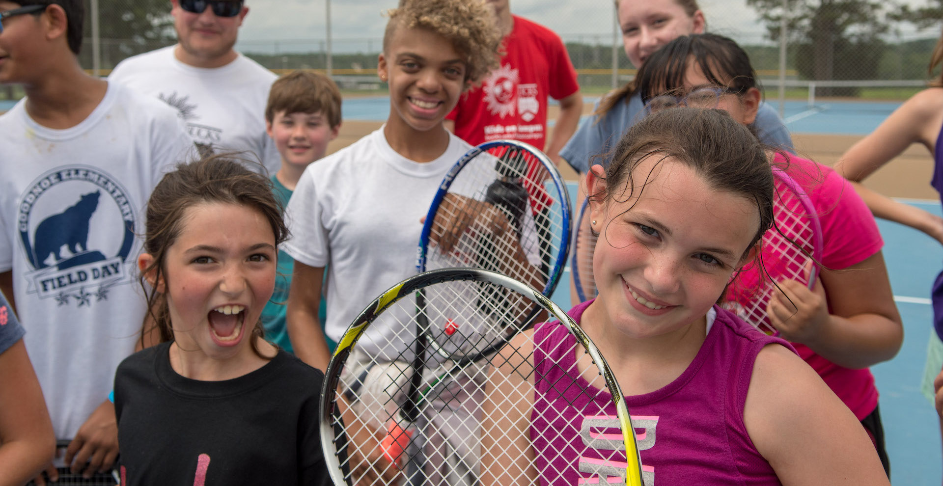 kids playing tennis outside