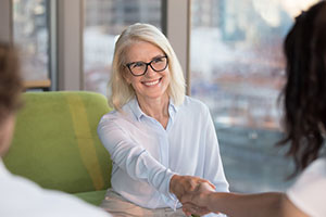 Mature female shaking hands
