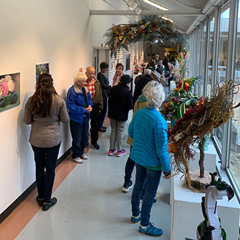 Art that blooms attendees looking at creations