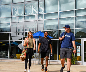Three students walking outdoors