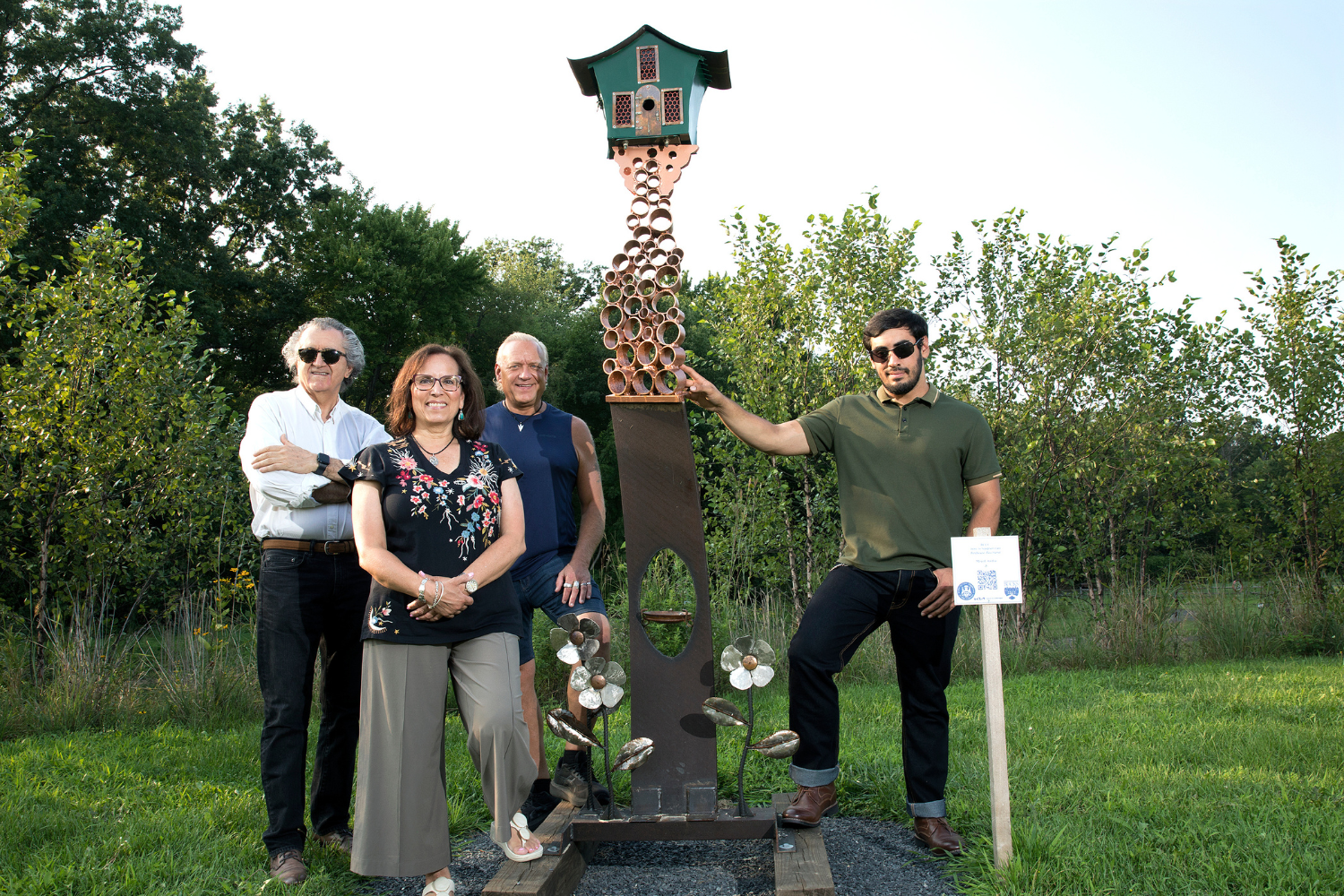 Students from Bucks County Community College's Intro to Sculpture Class show off their mixed media creation “Birdhouse Bacchanal,” which was chosen by visitors to Warrington’s Lions Pride Park to be purchased as the first piece for the township’s permanent outdoor art collection. Pictured (left-right) are Ali Vafaee of Princeton, Monique Perry of Churchville, Dave Miller of Yardley, and Ryan Rober