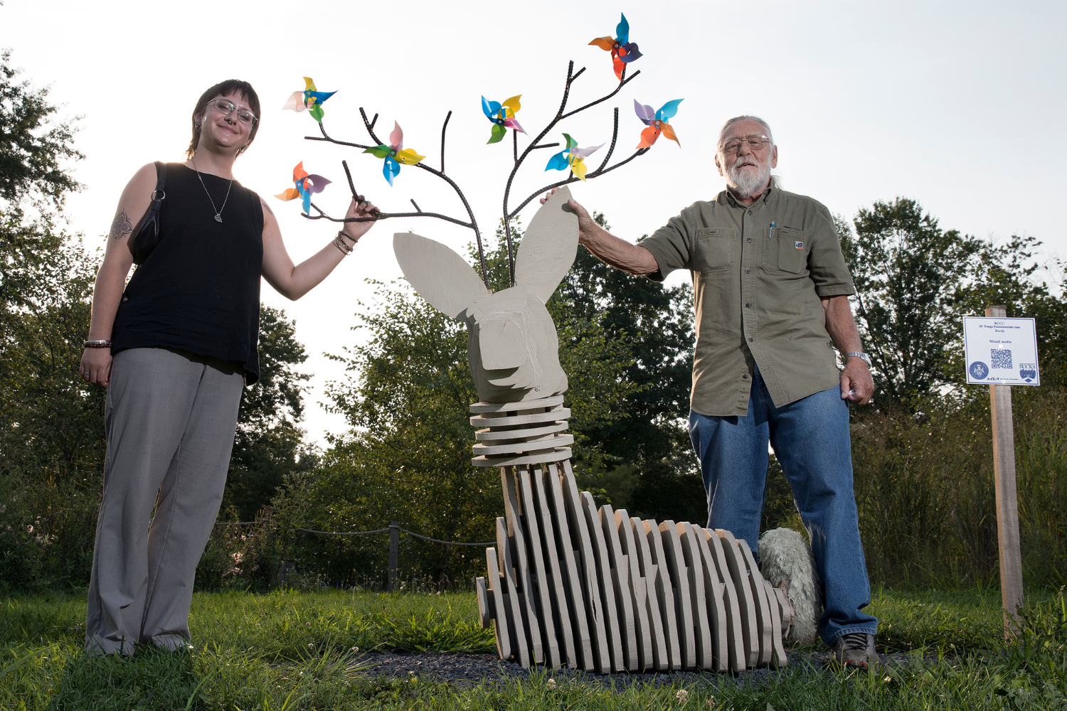 Charis Hasney, left, and Chuck Bennett of Wrightstown show off “Bucky,” which they created with their fellow students in a recent 3D Design Fundamentals Class at Bucks County Community College. The mixed media sculpture was among five works by students and alumni on display this summer along the walking trails at Warrington's Lion's Pride Park.
