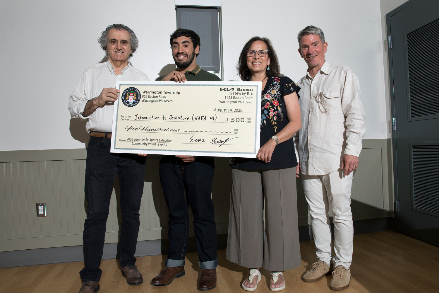 Bucks County Community College students (left-right) Ali Vafaee of Princeton, Ryan Roberts of Bensalem, and Monique Perry of Churchville accepted a $500 check from Warrington Township and Gateway Kia on August 14, joined by Clifford Eberly (right), the College’s senior manager of galleries and exhibitions.
