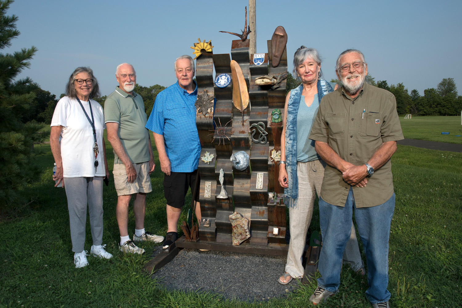 “Tapestry,” a mixed media sculpture created by students in Bucks County Community College’s Sculpture Foundry class, was one of five works that were part of an outdoor exhibition this summer at Warrington’s Lions Pride Park. Pictured with their creation are (left-right) Sunny Howard of Doylestown, Bill Sticker of Warminster, Bob Rauch of Upper Dublin, Cyna Worthman of Washington Crossing, and Chuc