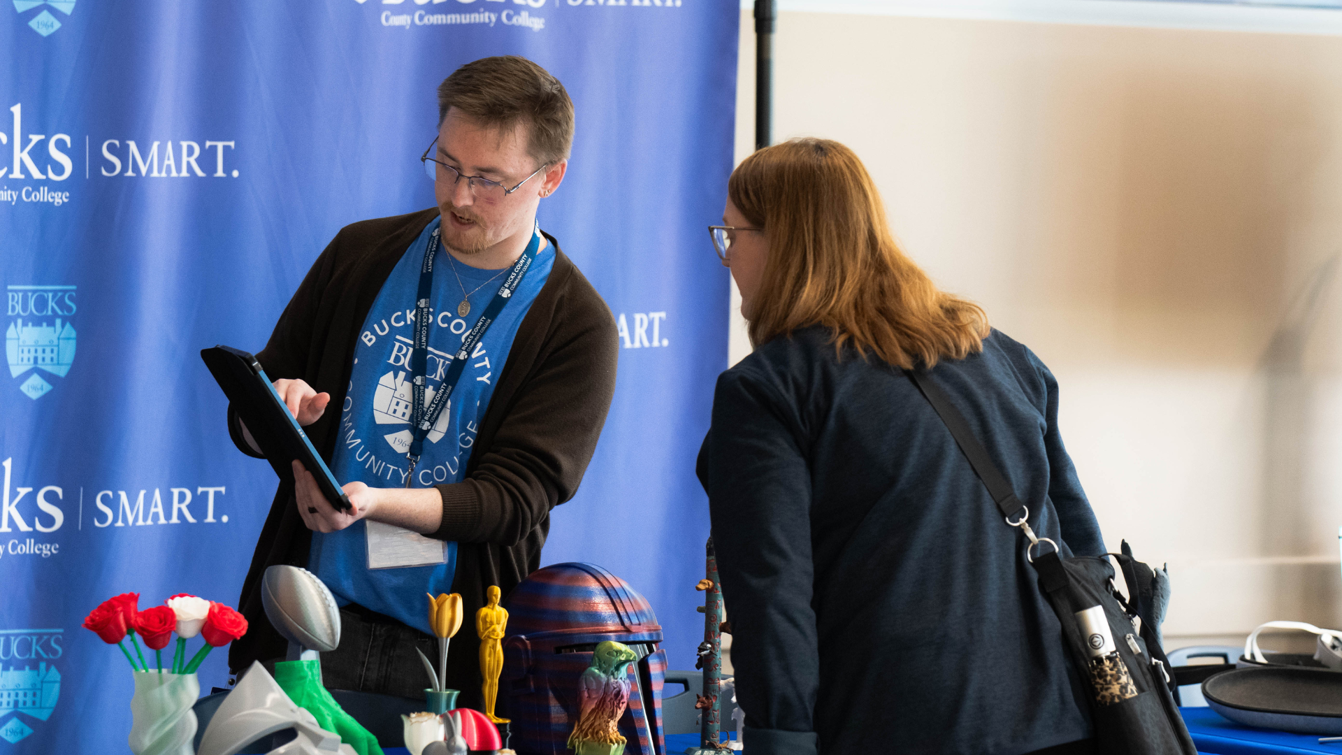 Bucks County Community College representative talking to a 3D Expo attendee