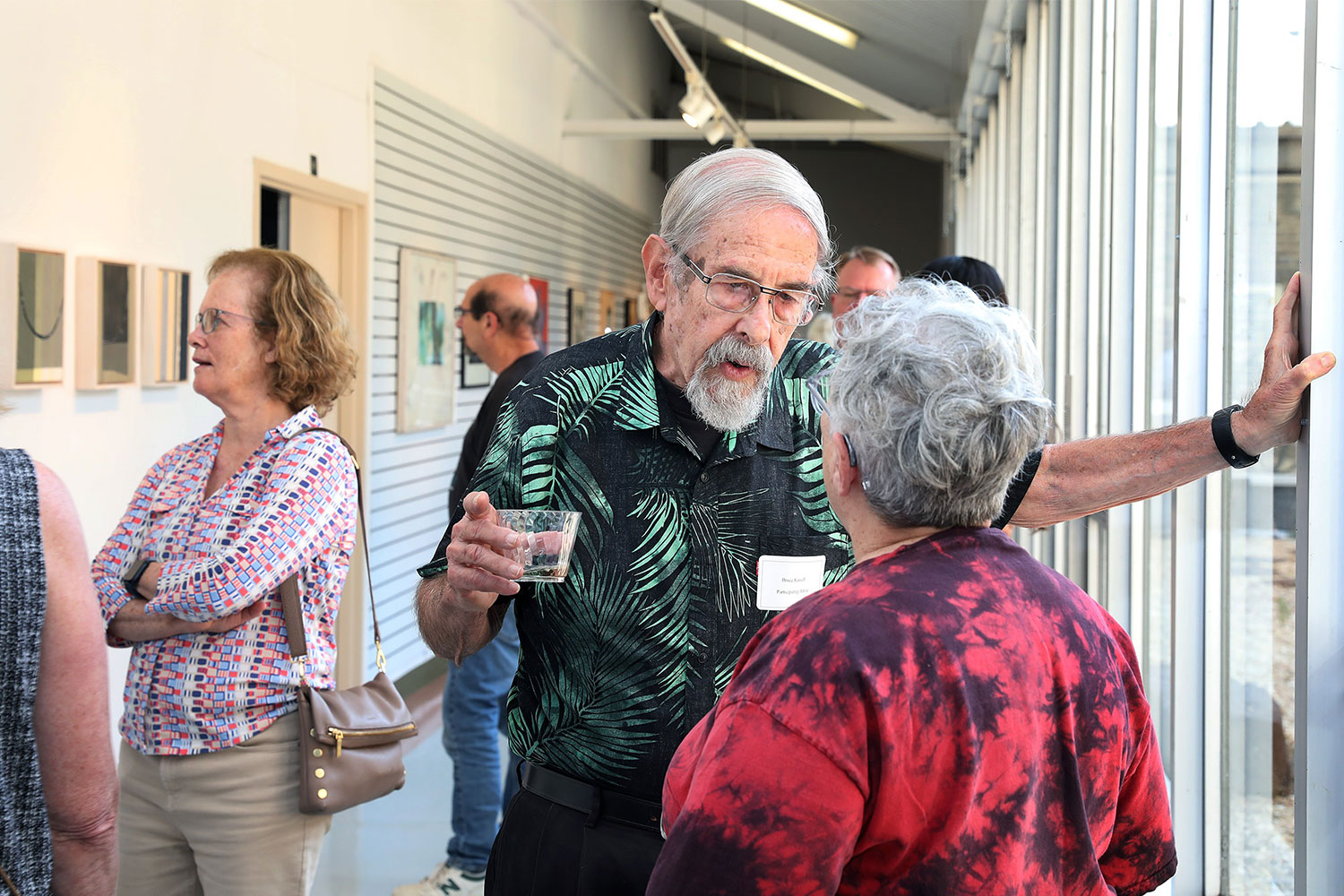 Bruce Katsiff talking with woman