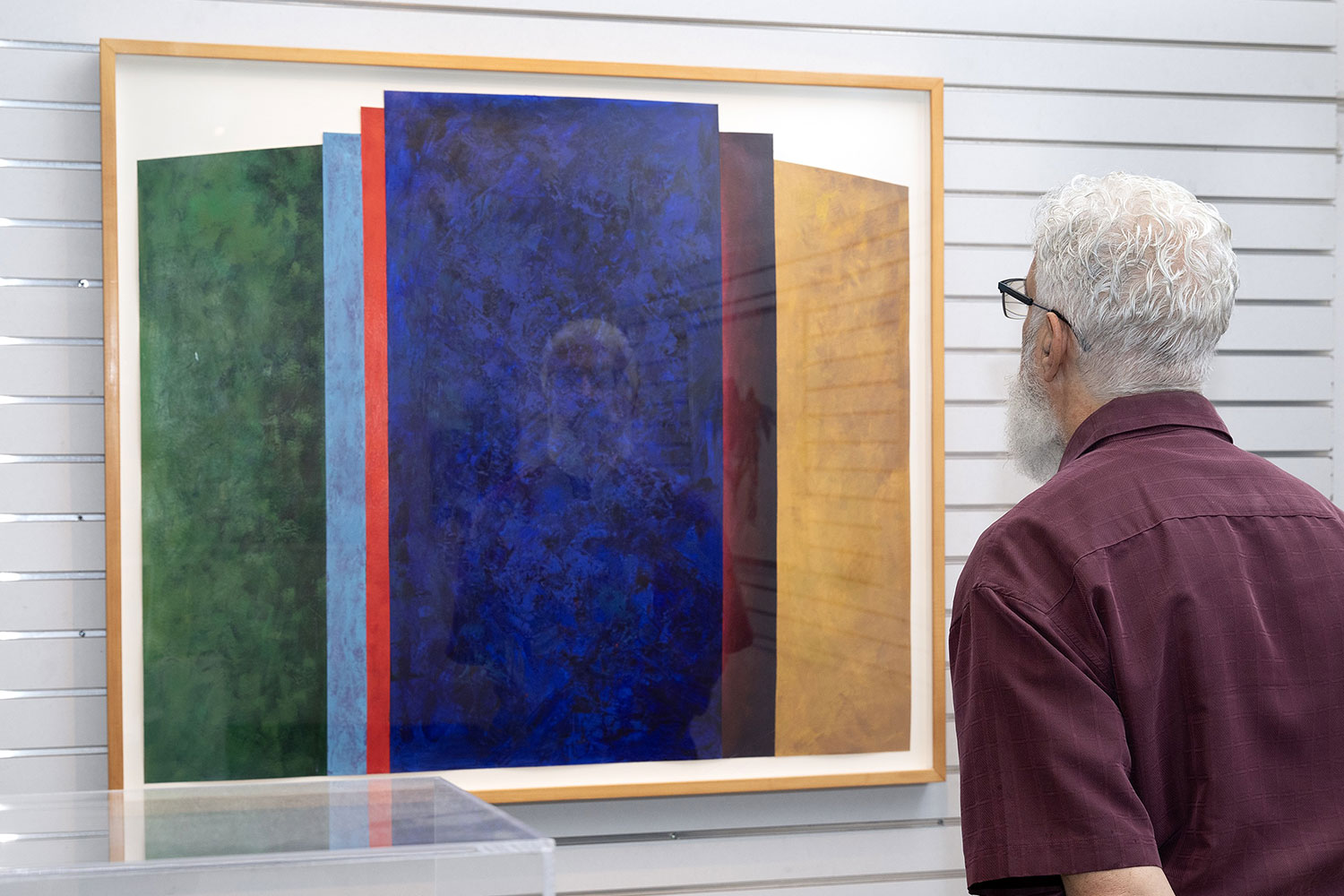 Male looking at large painting