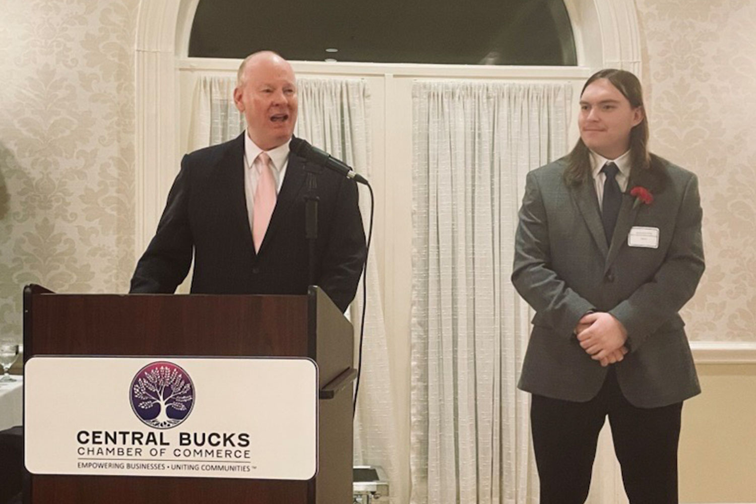 Dr. Patrick M. Jones at podium with Jamyz Lacey-Holly