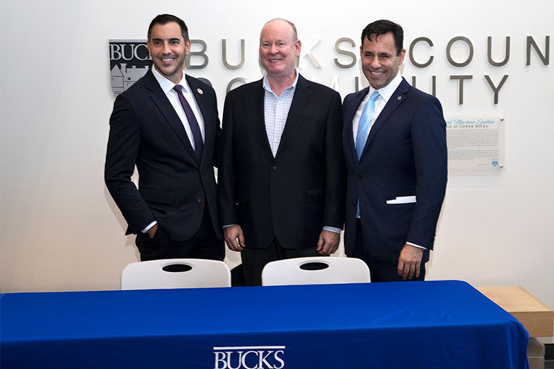 Bucks County Sheriff Danny Ceisler (left) and District Attorney Joe Kahn (right) greet Bucks County Community College President & CEO Patrick M. Jones (middle) at the opening reception