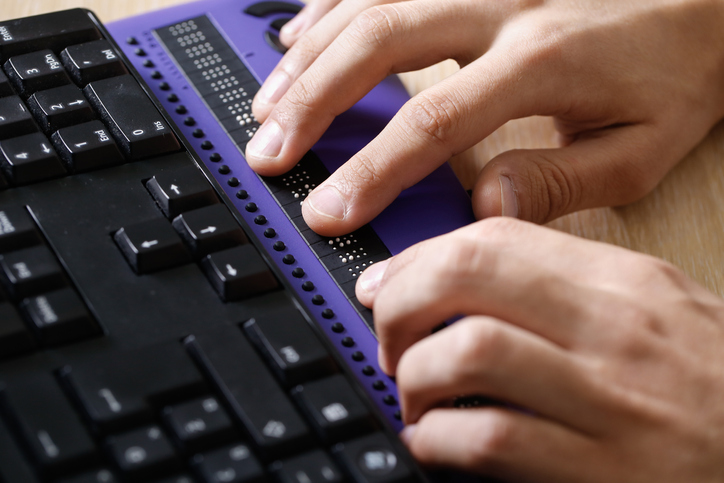 A person using a refreshable braille display