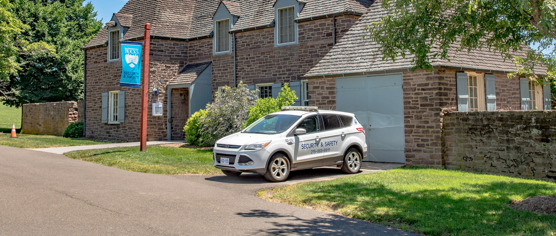 cottage with security vehicle parked out front